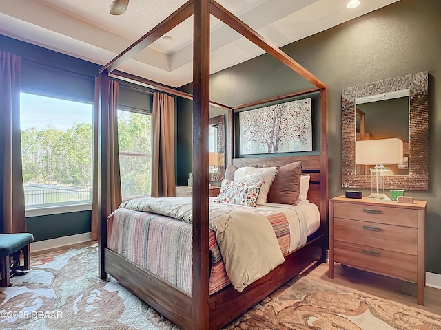 bedroom with light wood-style floors and baseboards