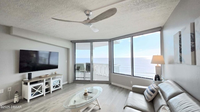 1133 Ocean Shore Blvd Unit 506, Ormond Beach, FL 32176 - living area featuring ceiling fan, wood finished floors, and a textured ceiling
