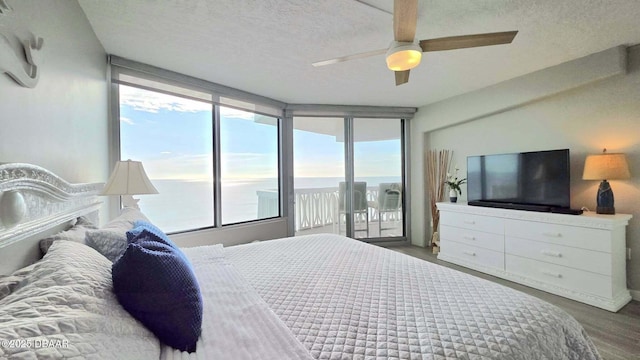1133 Ocean Shore Blvd Unit 506, Ormond Beach, FL 32176 - bedroom featuring access to outside, wood finished floors, a textured ceiling, and ceiling fan