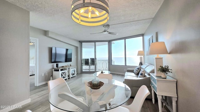 1133 Ocean Shore Blvd Unit 506, Ormond Beach, FL 32176 - dining room with a textured ceiling, a ceiling fan, and wood finished floors