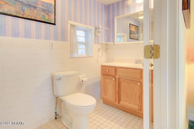 bathroom featuring tile patterned flooring, vanity, and toilet