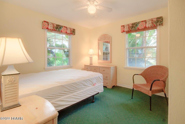 bedroom featuring carpet, multiple windows, and ceiling fan