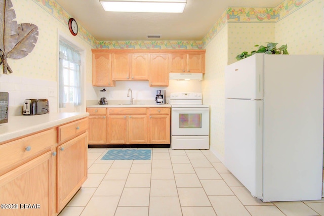 kitchen featuring light tile patterned flooring, light brown cabinetry, white appliances, and sink