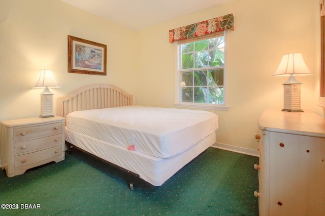 bedroom featuring dark colored carpet