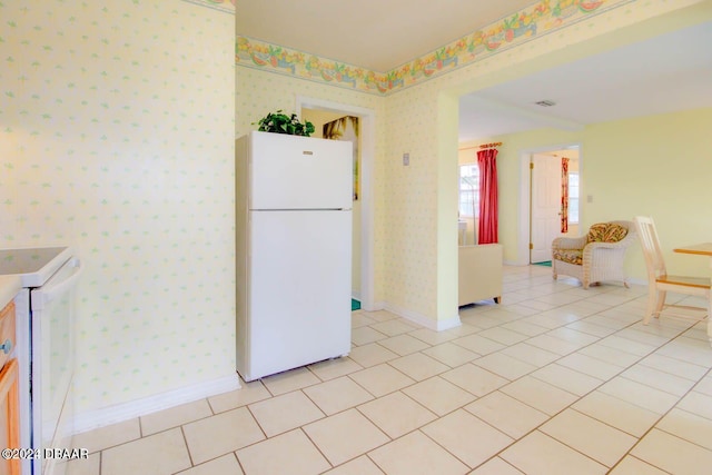 kitchen featuring white appliances and light tile patterned floors