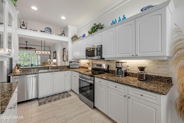 3017 Glin Cir, Ormond Beach, FL 32174 - kitchen with stainless steel appliances, ornamental molding, white cabinets, tasteful backsplash, and recessed lighting
