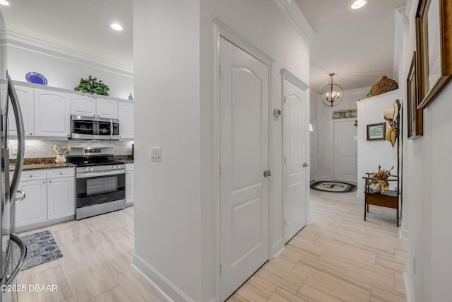 3017 Glin Cir, Ormond Beach, FL 32174 - hall featuring crown molding, a chandelier, and recessed lighting