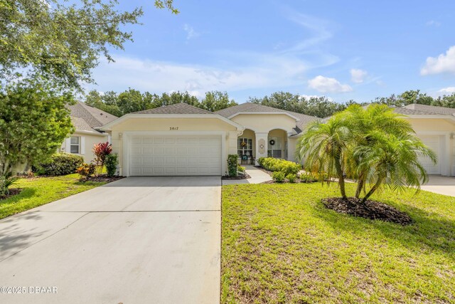 3017 Glin Cir, Ormond Beach, FL 32174 - view of front of home with a garage, driveway, a front lawn, and stucco siding