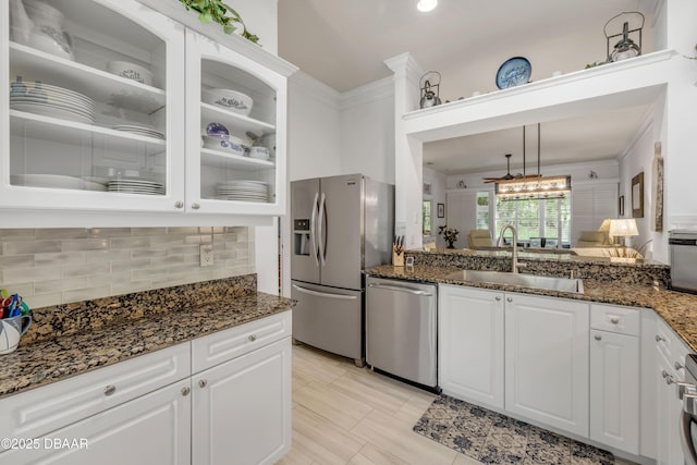 3017 Glin Cir, Ormond Beach, FL 32174 - kitchen with appliances with stainless steel finishes, tasteful backsplash, white cabinets, glass insert cabinets, and ornamental molding