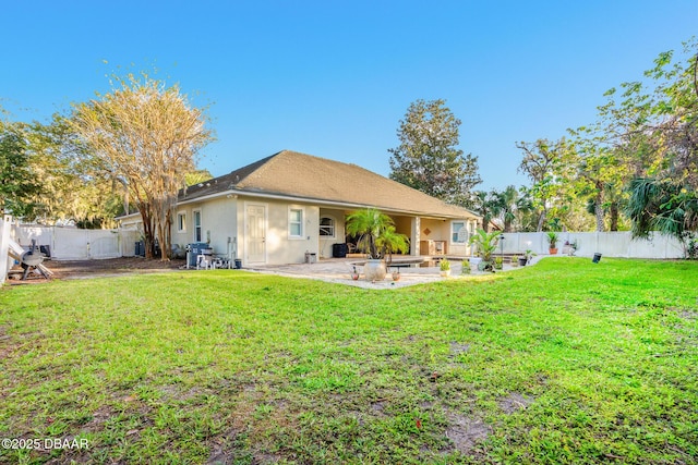 rear view of property featuring a yard and a patio