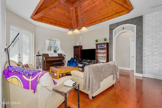 living room featuring french doors, hardwood / wood-style flooring, a raised ceiling, and wooden ceiling