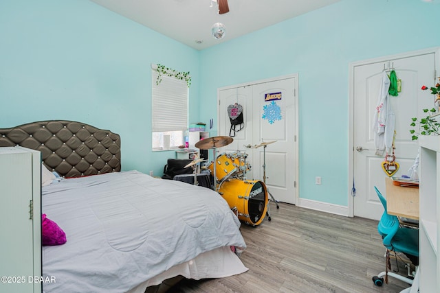 bedroom with hardwood / wood-style floors and ceiling fan