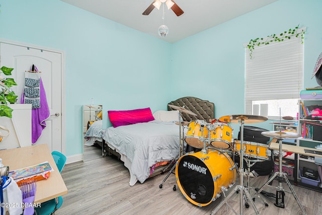 bedroom with hardwood / wood-style floors and ceiling fan