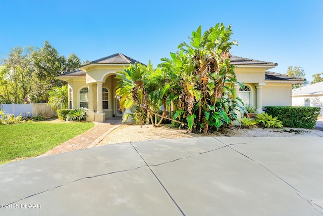 mediterranean / spanish house with a front yard