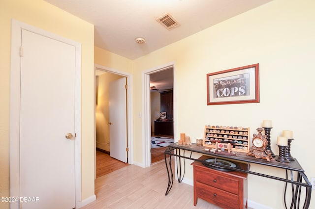 corridor with light hardwood / wood-style flooring