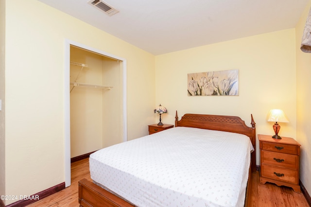 bedroom with a closet and light hardwood / wood-style flooring