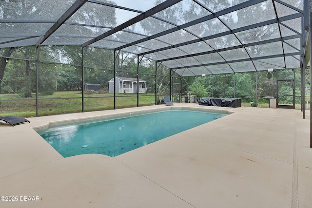 view of swimming pool with a patio, a lanai, and a lawn