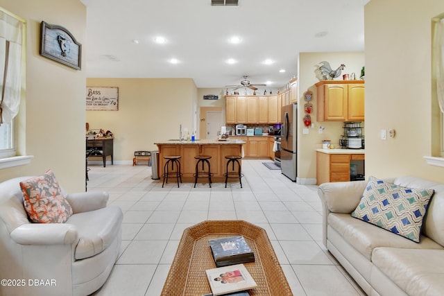 living room featuring ceiling fan and light tile patterned floors