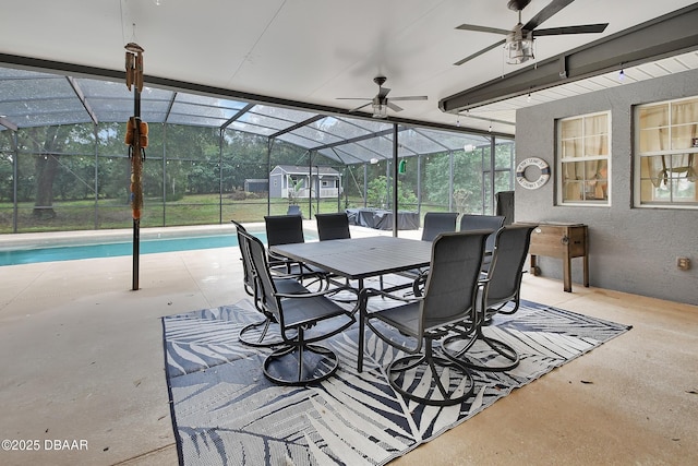 view of patio featuring glass enclosure and ceiling fan