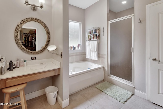 bathroom with tile patterned floors, vanity, and shower with separate bathtub