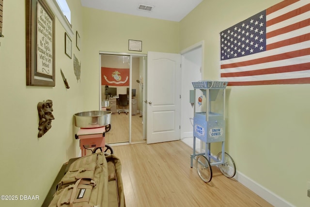 hallway with hardwood / wood-style floors