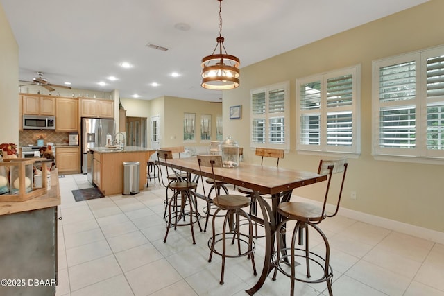 dining room featuring ceiling fan and light tile patterned flooring