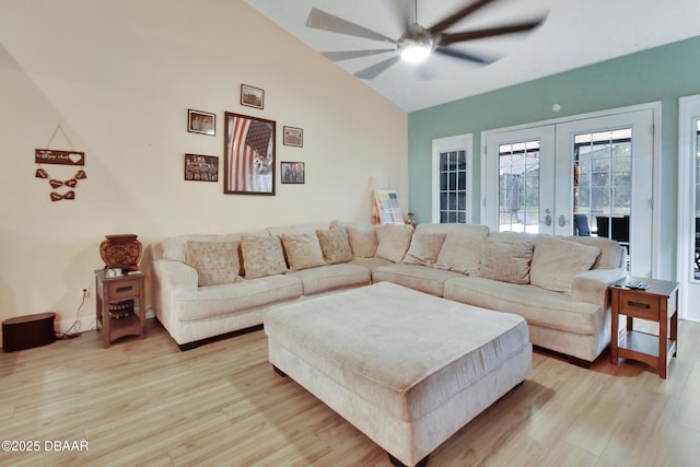 living room featuring french doors, light wood-type flooring, ceiling fan, and lofted ceiling