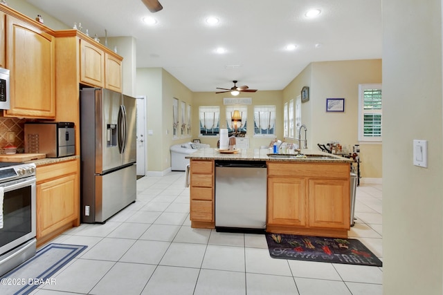 kitchen with ceiling fan, stainless steel fridge with ice dispenser, fridge, light tile patterned floors, and range