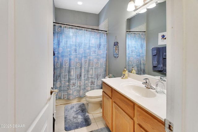 bathroom with tile patterned flooring, vanity, and toilet