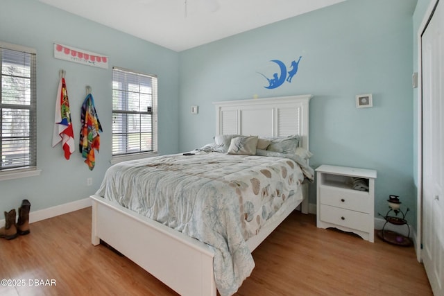 bedroom featuring light wood-type flooring and a closet