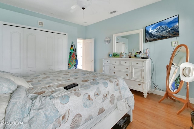 bedroom with ceiling fan, a closet, and light wood-type flooring