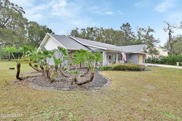 view of front of property featuring a garage and a front lawn