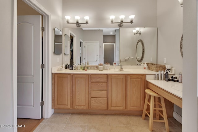 bathroom featuring tile patterned flooring, vanity, and walk in shower