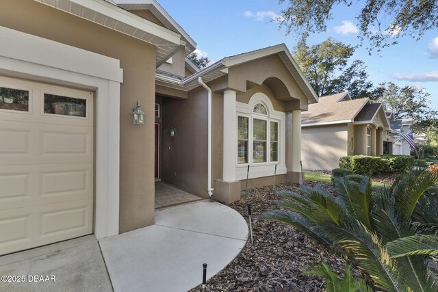 view of exterior entry featuring a garage