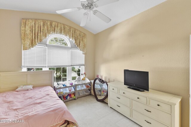 bedroom featuring ceiling fan, lofted ceiling, and light carpet