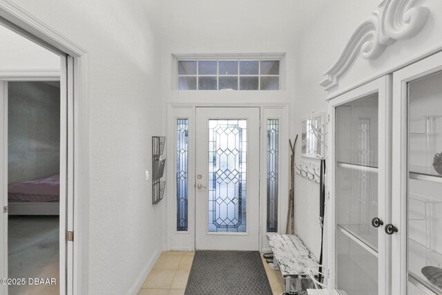 foyer entrance featuring light tile patterned flooring