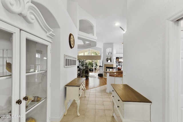 hallway featuring light tile patterned flooring