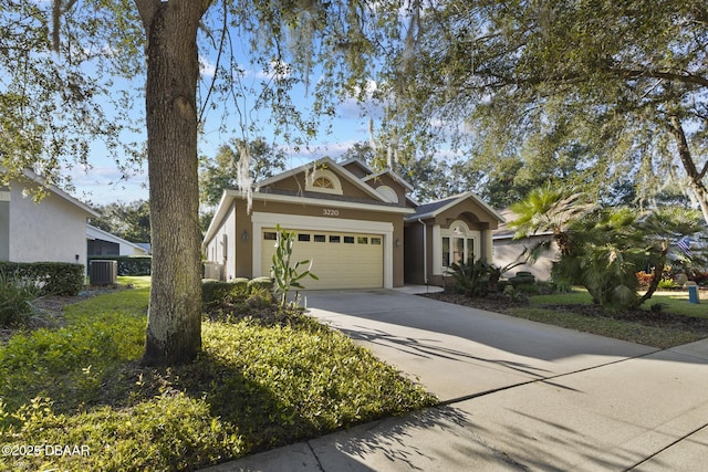 view of front of home with a garage and central air condition unit