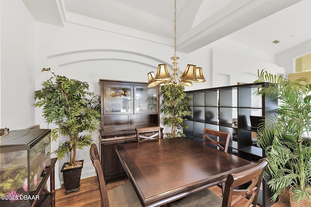 dining space featuring hardwood / wood-style floors and a notable chandelier