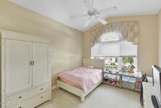 carpeted bedroom with ceiling fan and vaulted ceiling