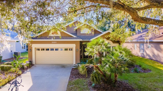 craftsman-style house with central AC unit and a garage