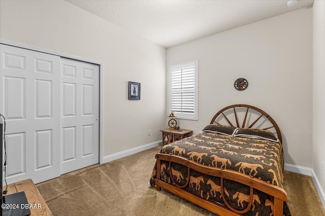 carpeted bedroom with a closet and a textured ceiling