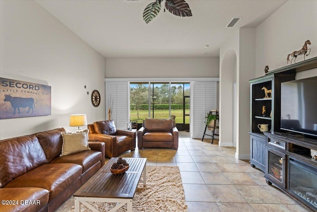 living room featuring light tile patterned flooring and ceiling fan