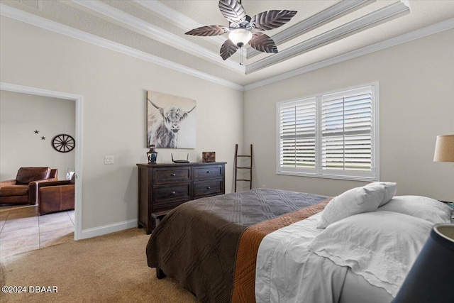 bedroom with ceiling fan, a raised ceiling, crown molding, and light colored carpet