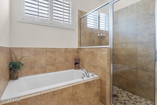 bathroom featuring separate shower and tub