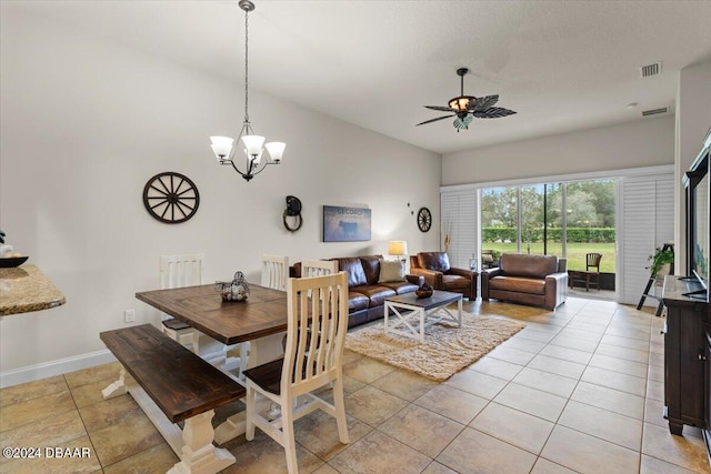 tiled dining space with ceiling fan with notable chandelier