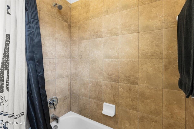 bathroom with shower / bath combo with shower curtain