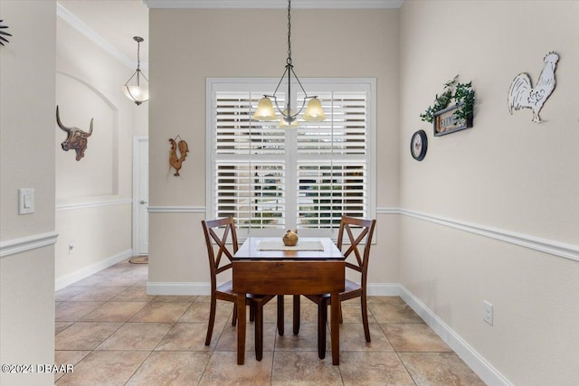 dining room featuring ornamental molding, a chandelier, and light tile patterned flooring