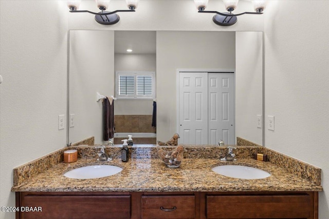 bathroom with vanity and a bathing tub