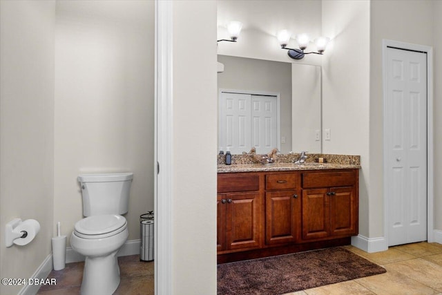 bathroom with tile patterned flooring, vanity, and toilet